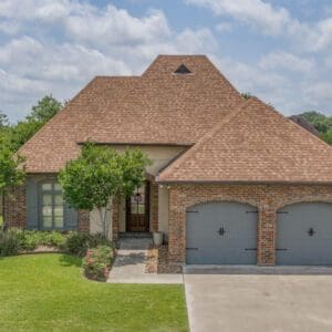 A large brick house with two garage doors.