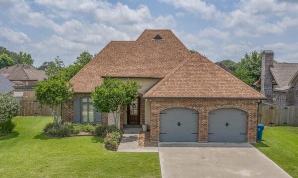 A large brick house with two garage doors.