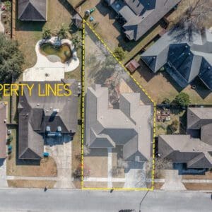 A aerial view of houses with yellow lines on the ground.