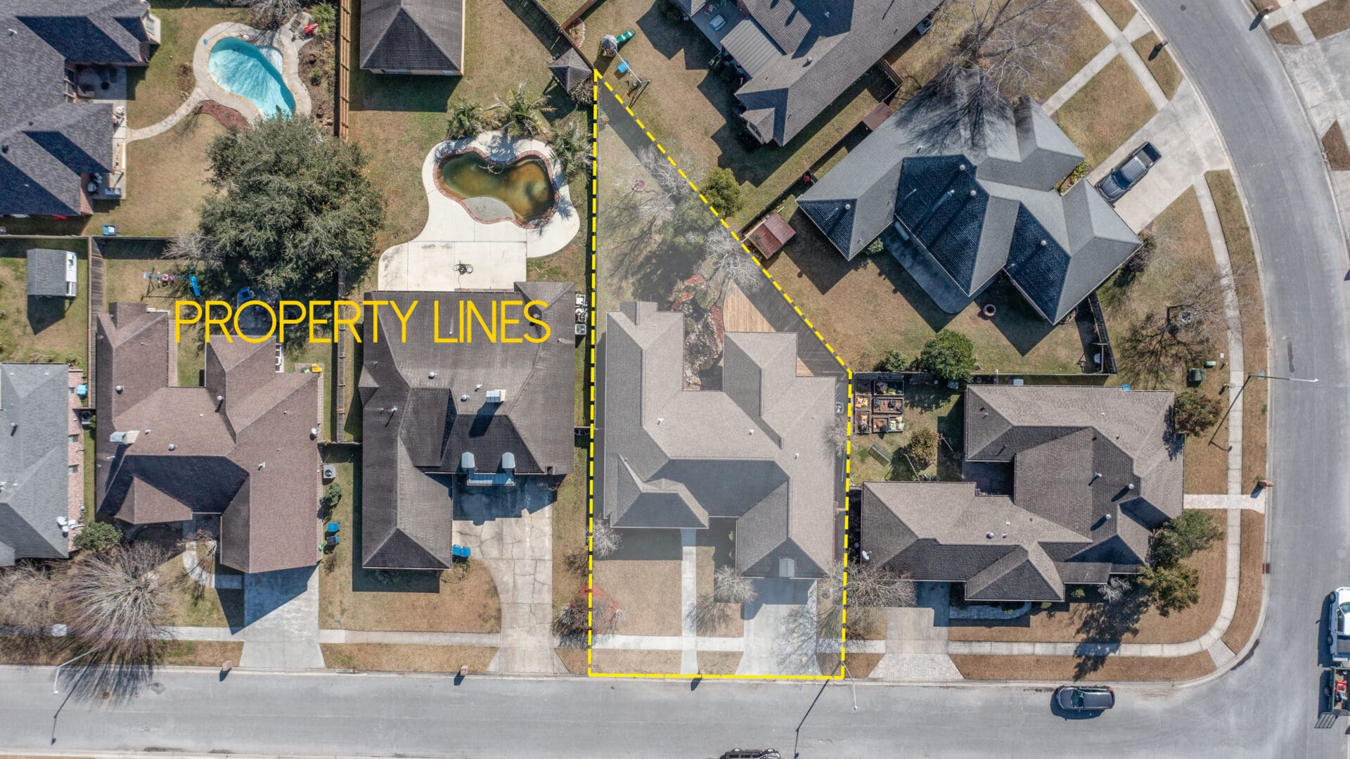 A aerial view of houses with yellow lines on the ground.